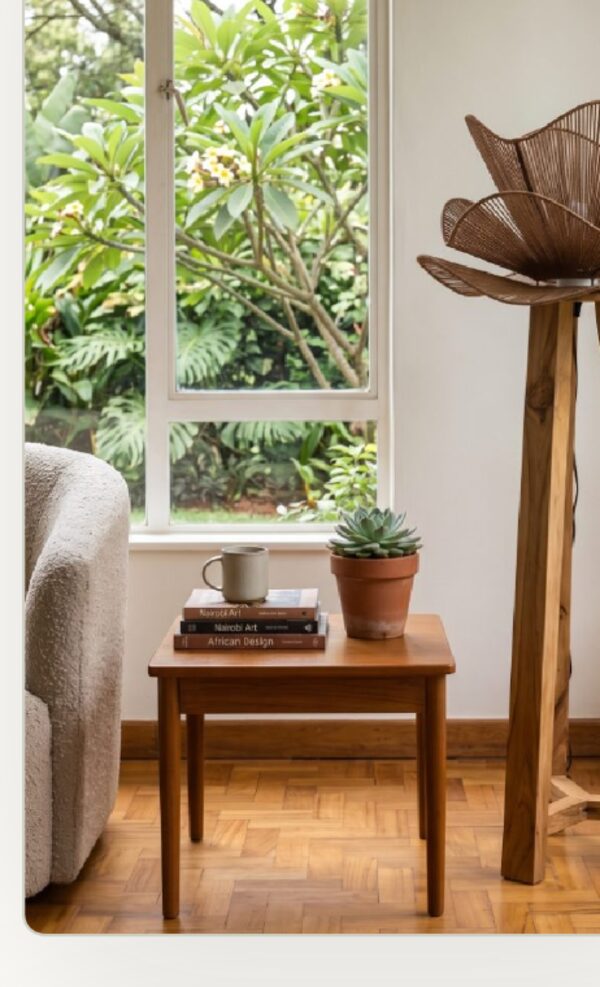 Woven petal lamp beside a Karen garden window